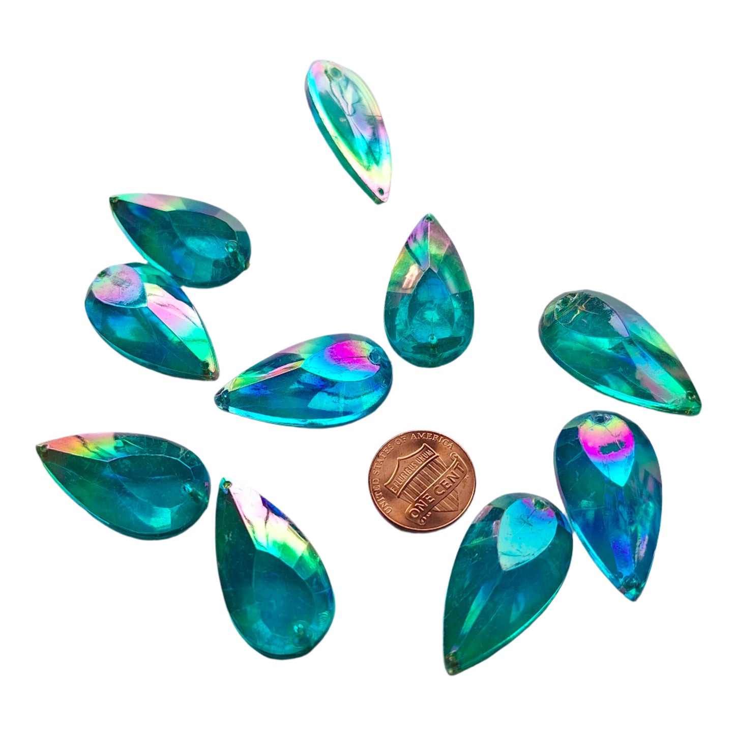 Aqua AB teardrop cabochons shown together, including one flipped to show the sew-on back, with a penny for scale.