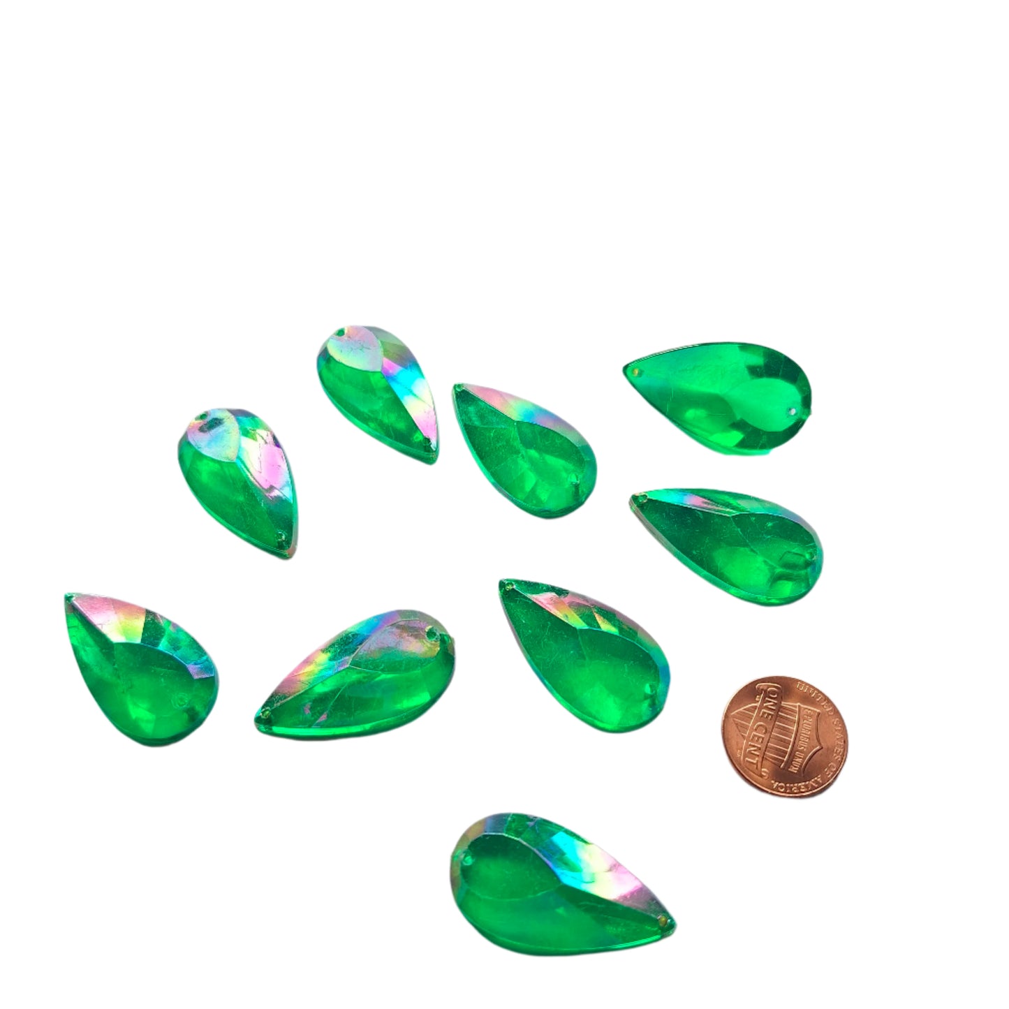 Emerald AB teardrop cabochons shown together, with a penny for scale.