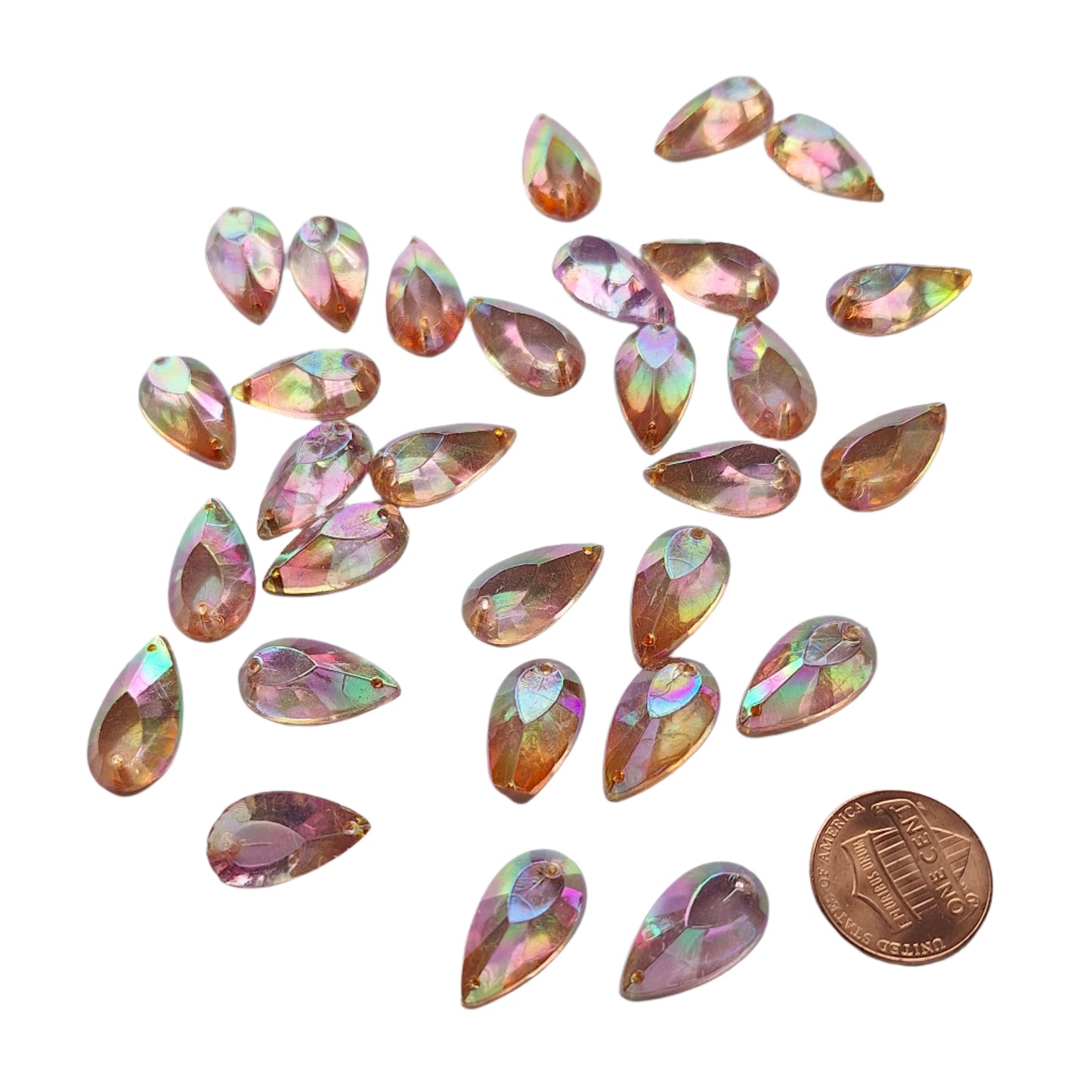 Amethyst AB teardrop cabochons shown in a group, with a penny for scale.