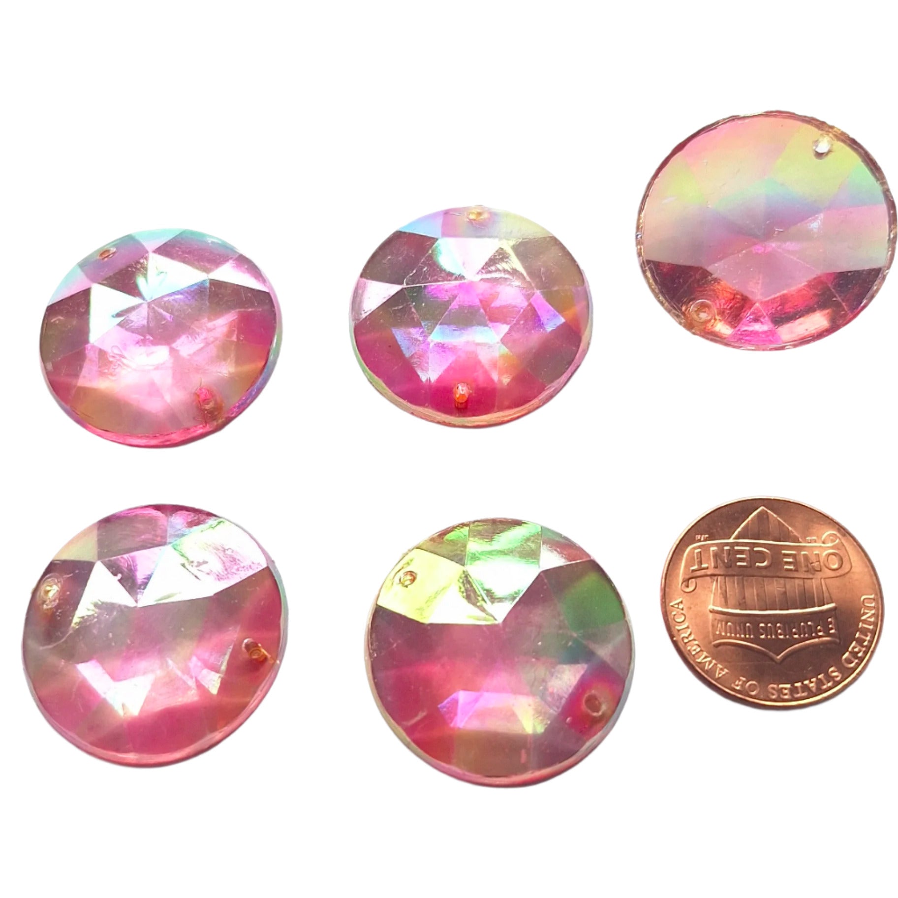 Amethyst AB round faceted plastic cabochons arranged in a group of five, with one flipped to show the two-hole sew-on back; penny included for scale.