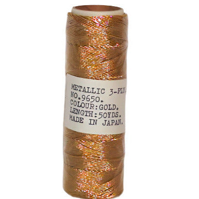 Metallic gold 3-ply lamé thread on a 50-yard spool