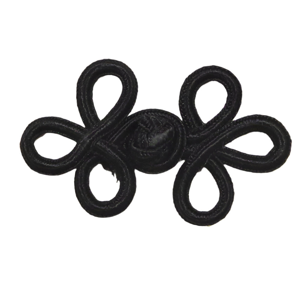 A black soutache frog closure with looped cord construction measuring 57×38mm.
