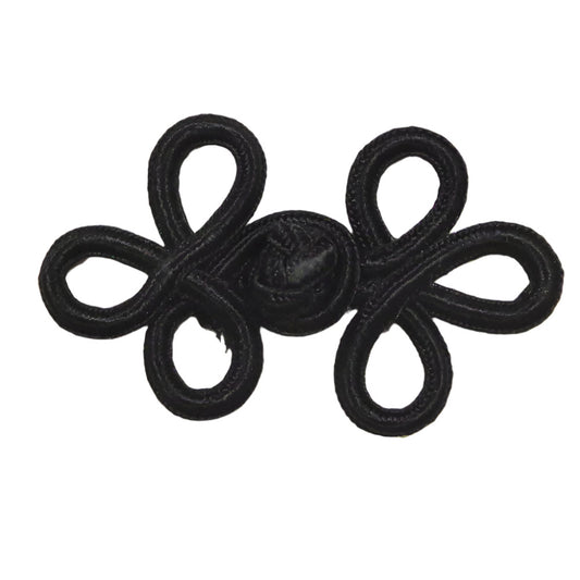 A black soutache frog closure with looped cord construction measuring 57×38mm.