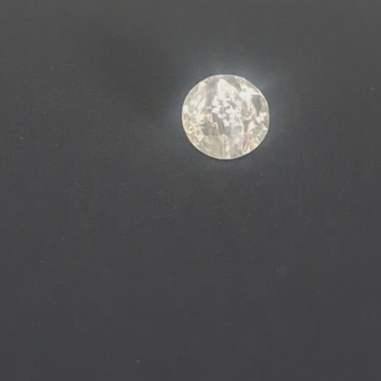 Faceted clear mirrored glass button with irregular rocky, diamond-like surface and pointed profile, channel shank, 14mm/22L, shown in video with light movement to display the mirrored finish and back.