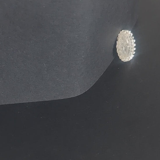 Mirrored glass two-hole flat button with raised rim, shown in video with light movement to display the mirrored finish.