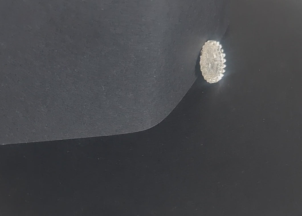 Mirrored glass two-hole flat button with raised rim, shown in video with light movement to display the mirrored finish.