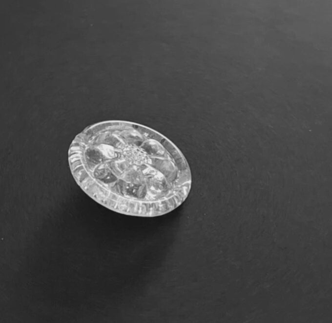Mirrored glass button with swirl design, 29mm shown in video with light movement to display the mirrored finish.