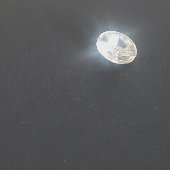 Clear glass button with a raised geometric starburst design and faceted surface, 18mm/28L, , shown in video with light movement to display the mirrored finish.