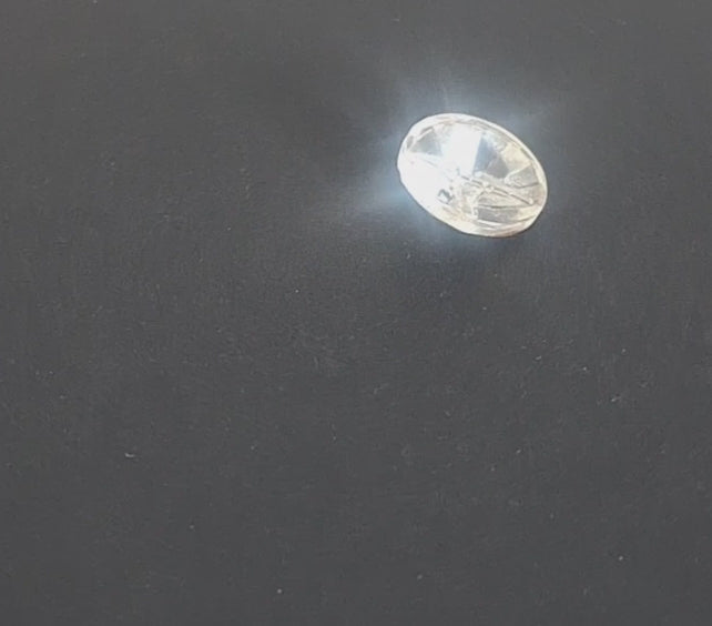 Clear glass button with a raised geometric starburst design and faceted surface, 18mm/28L, , shown in video with light movement to display the mirrored finish.