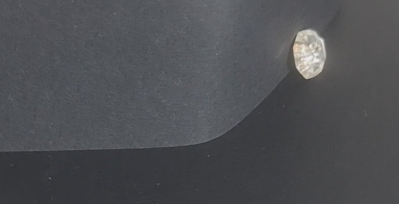 Mirrored glass button, 8-sided shape with four holes, 14mm, , shown in video with light movement to display the mirrored finish.