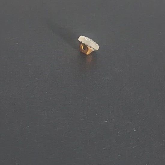 Mirrored glass button with pebbled textured surface and shank attachment, 10mm, shown in video with light movement to display the mirrored finish and back.