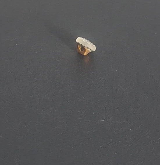 Mirrored glass button with pebbled textured surface and shank attachment, 10mm, shown in video with light movement to display the mirrored finish and back.