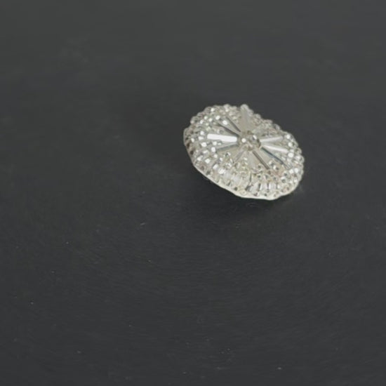 Video of a silver beaded round button with radiating tube beads forming a clustered circular pattern
