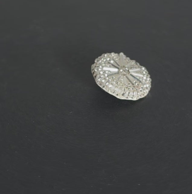 Video of a silver beaded round button with radiating tube beads forming a clustered circular pattern