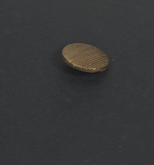 Video of a gold metalized ribbed glass button with shank back, 18mm.