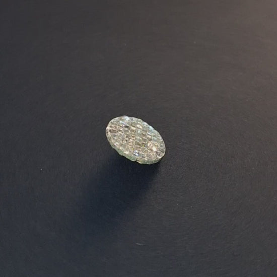 Mirrored glass button with pebbled textured surface and shank attachment, 18mm, shown in video with light movement to display the mirrored finish.